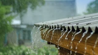 a scene of rainfall falling over tin roof